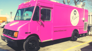 A pink food truck parked in a parking lot of apartments in The Woodlands TX.