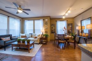 A spacious living room in The Woodlands TX apartment, complete with a comfortable couch and elegant table.