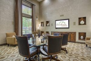 An elegant conference room with comfortable chairs and a high-quality TV, available for rent in The Woodlands, TX.