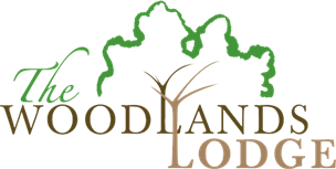 The Woodlands Lodge logo prominently displays the essence of apartments in The Woodlands, TX.