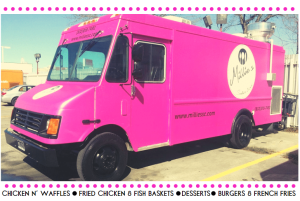 A pink food truck parked in a parking lot in The Woodlands, TX.