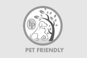 Apartments in The Woodlands For Rent Icon depicting a dog and a cat sitting beneath a tree with the words "PET FRIENDLY" written below it, perfect for highlighting pet inclusivity on your home page. The Woodlands Lodge Apartments 2500 S Millbend Dr, The Woodlands, TX 77380